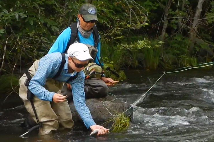 Guide Andrew Harris and guest release a trout