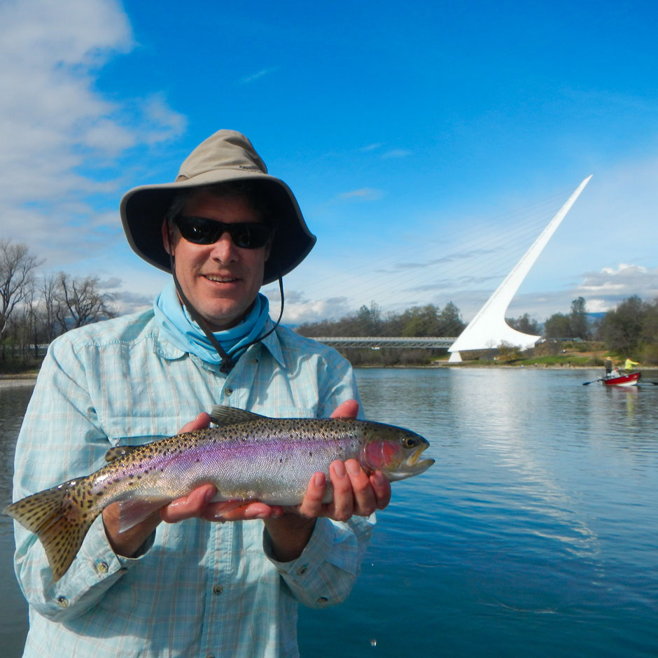 An angler with a wild trout caught near the Sundial Bridge